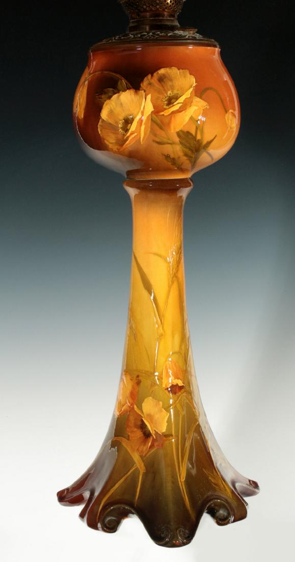 A FINE AND RARE ROOKWOOD BANQUET LAMP SIGNED DALY: Matthew A. Daly Dated 1894 A gorgeous glowing example of Rookwood's early standard glaze. the slip decoration of poppy flowers and, in some areas, wheat stalks against subtle shaded hues of gold, brow