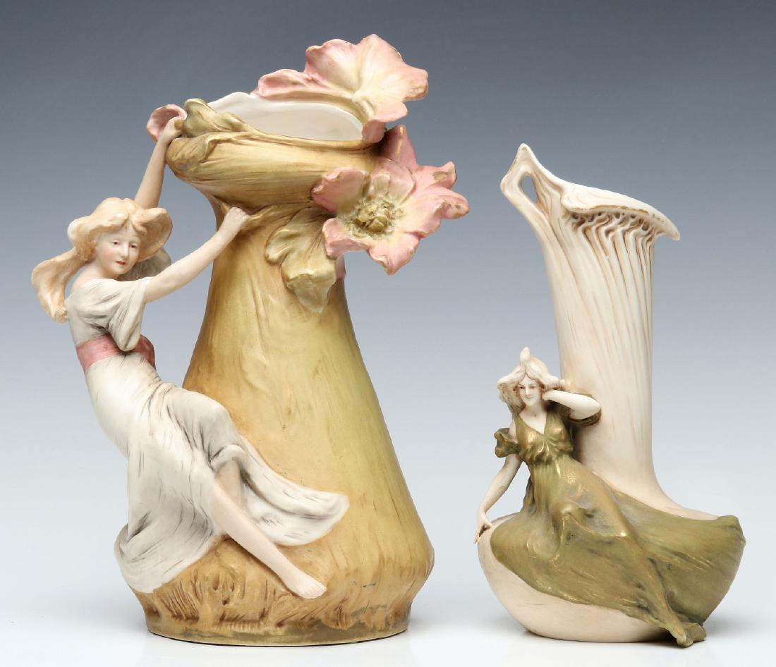 ROYAL DUX AR NOUVEAU PORCELAIN VASES WITH LADIES: Two examples of strong Art Nouveau influence, each with pink porcelain signature tag under side of the base. Measure size range from 9.5 to 11.25 inches. We happily provide seamless in-house packing a