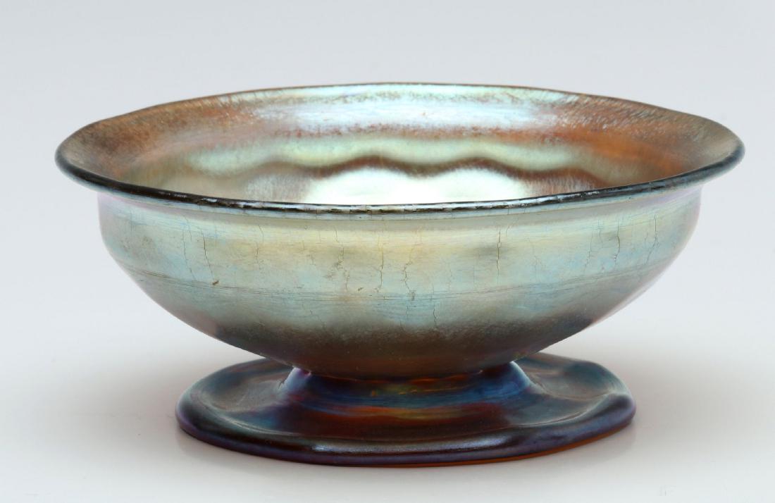 A TIFFANY FAVRILE BLUE/GOLD ART GLASS MASTER SALT: 1900-1920 The footed cellar with wheel engraved signature of 'L.C.T.' on the underside of the foot. Measures 1.75 x 4 inches. We happily provide seamless in-house packing and shipping services on near