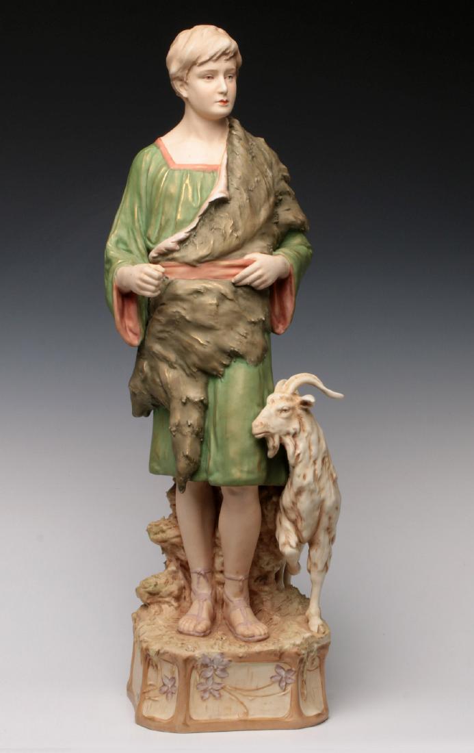 A 26-INCH ROYAL DUX CLASSICAL FIGURE OF YOUNG MAN: A young man wearing sandals, classical robe and skins, on an eight-sided naturalistic base with goat, pink triangle mark on the underside of the base. Measures 26 x 7 x 6 inches. We happily provide se