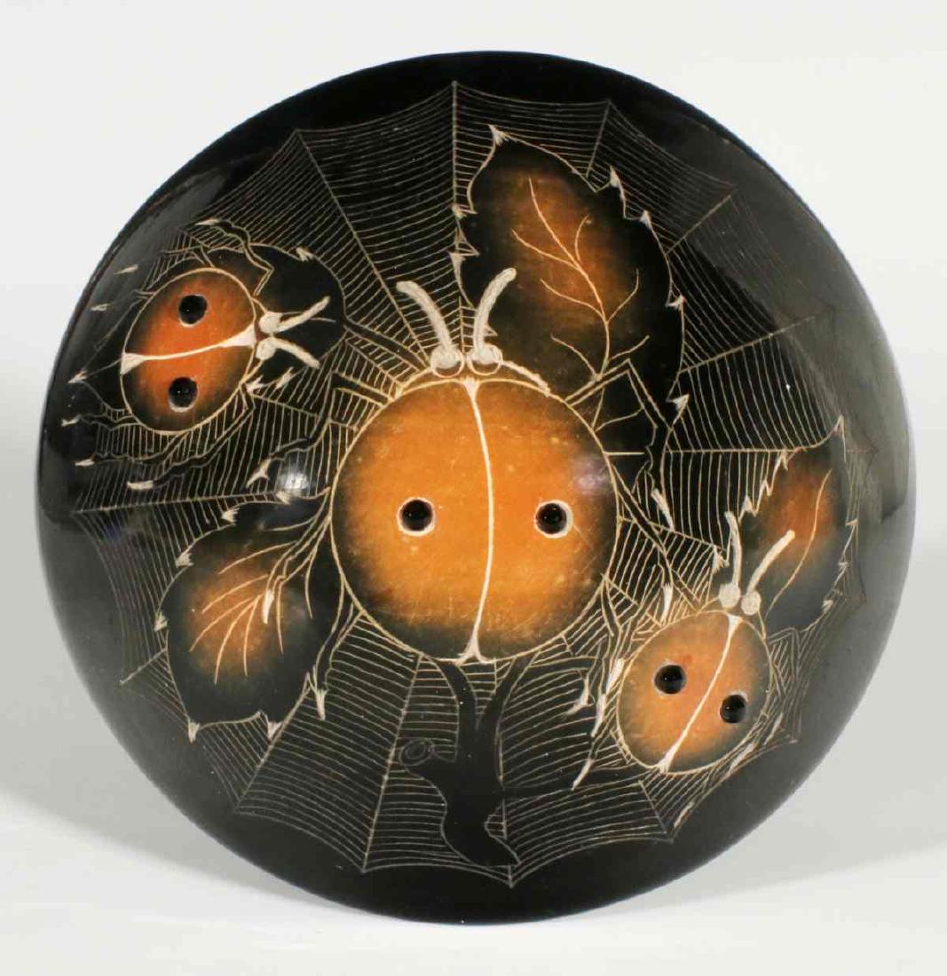 A SAN ILDEFONSO SEED JAR SIGNED STAHN-MOO-WHE: Barbara Gonzales 'Stahn Moo Whe' (Born 1947) A blackware seed jar with sgraffito decoration of lady bugs, spider, and web embellished by applied beads, signed 'Stahn-Moo-Whe.' Measures 2.25 x 3.75 inc
