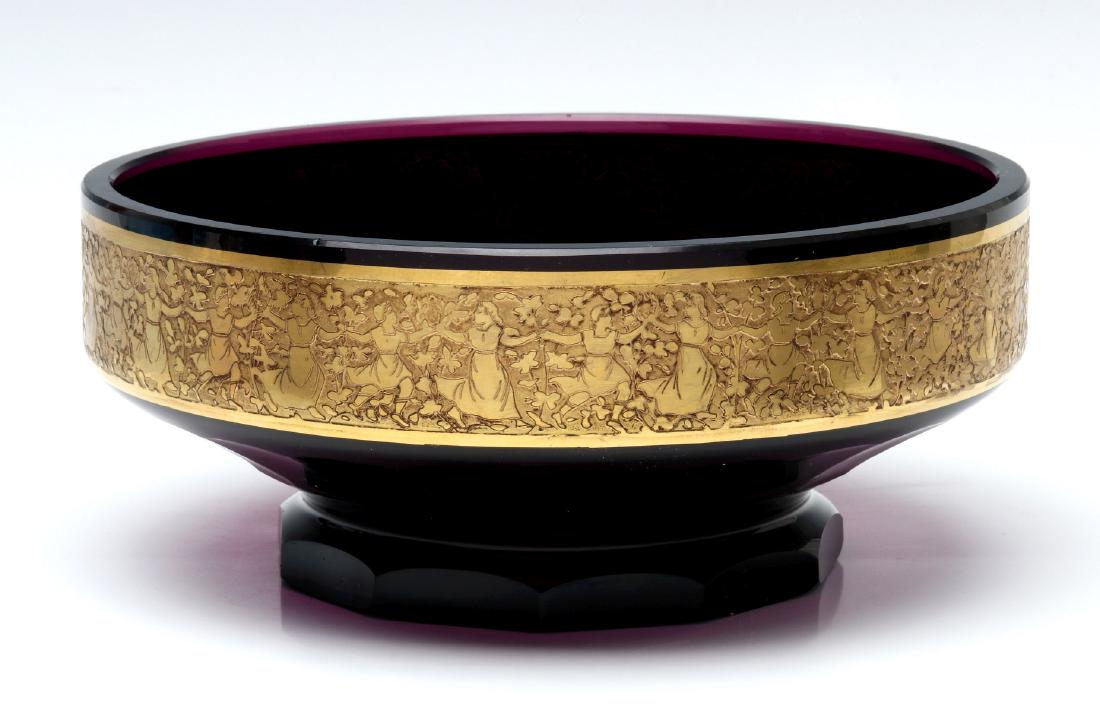 A POLISHED MOSER CONSOLE WITH GILT CUT BACK FRIEZE: Circa 1925. The faceted and polished amethyst glass footed console bowl with band of dancing figures in gilded cut-back decoration, unsigned. Measures 3.5 x 8.25 inches. We happily provide seamless in