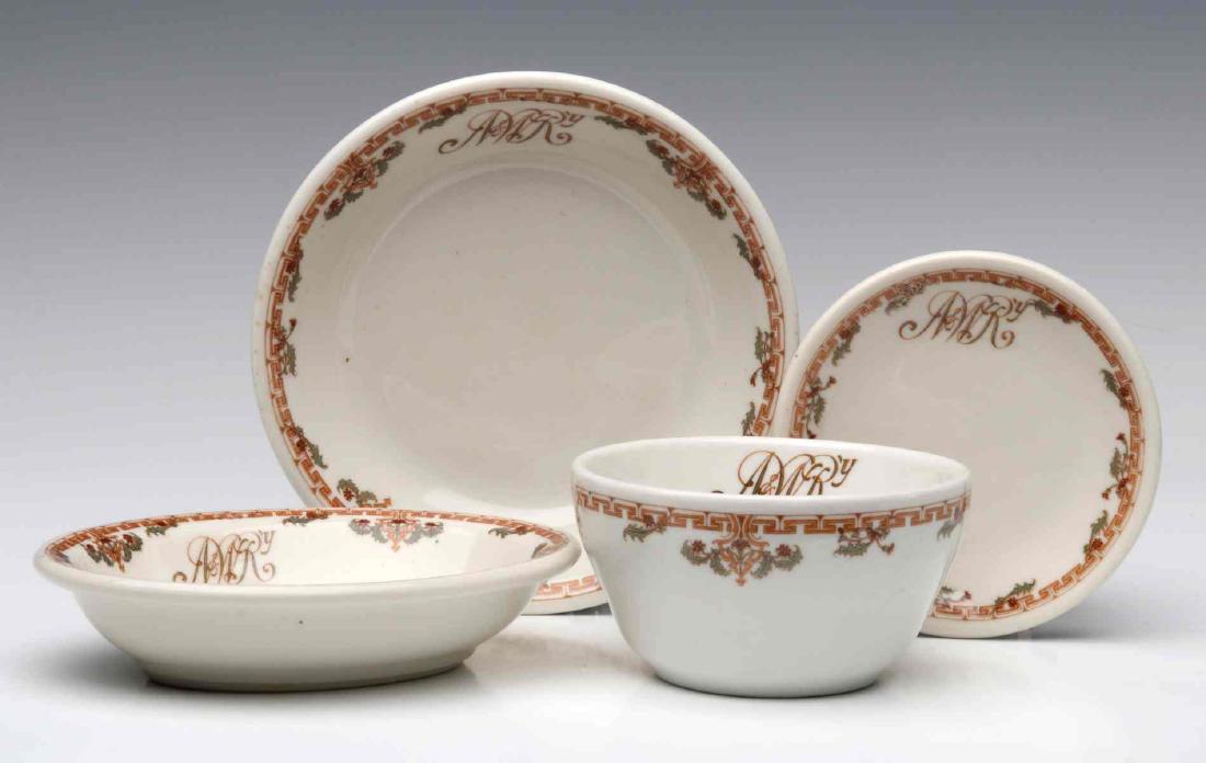 NORFOLK & WESTERN RAILROAD DINING CAR CHINA: A small bowl, butter pat, a small oval dish and a bullion cup, each with the N&W Ry cypher, and backstamped Lamberton Scammell, oval dish additionally stamped Ivory. Bowl measures 1.25 x 5.5 inches, b