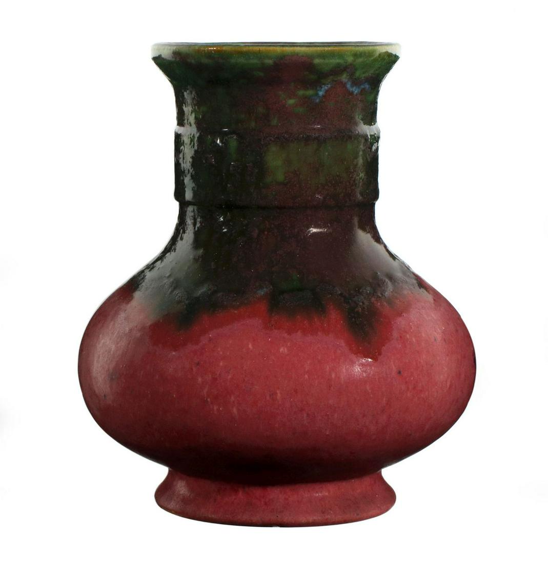 A LARGE FULPER ART POTTERY URN IN UNUSUAL GLAZE: The green and brown mottled gloss glaze with blue tinge over variegated matte plum red, vertical etched mark on the underside of the base. Measures 10 x 8 inches. We happily provide seamless in-house