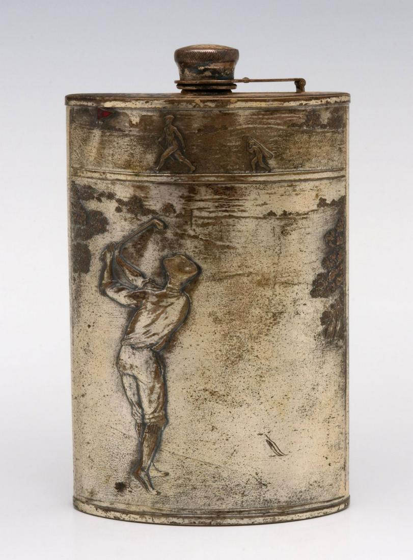 A CIRCA 1920 POCKET FLASK WITH GOLFER: The white metal flask with embossed scenes of a golfer in vintage garb and golfer with caddy heading for the '19th hole' highlighted in red enamel, signed 'Evans Nickel Silver' on the cap hinge. Measu