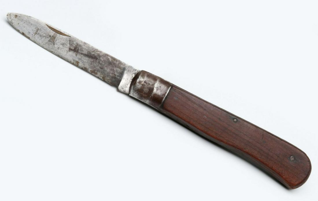 GERMAN WWI KNIFE AND BANNER COLLECTED BY GI BEN DAVIS: A wood-sided knife marked on the tang, plus a large banner. with sewn emblem. Knife measures 7.5 inches, banner measures 58.5 x 60 inches. We happily provide seamless in-house packing and shipping ser