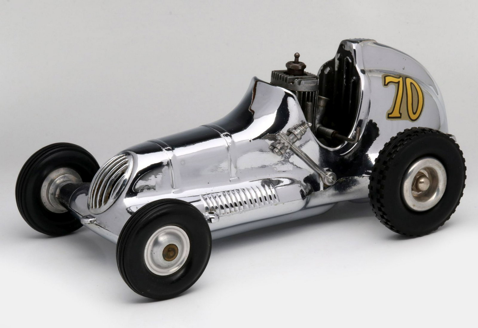 A ROY COX THIMBLE DROME CHROMED ALUMINUM TETHER CAR: The classic racer embossed Roy Cox THIMBLE DROME CHAMPION Champion Made in Santa Ana Calif underside, complete with motor, chromed aluminum body. Measures 4 x 9.75 inches. Provenance: The 45-year coll