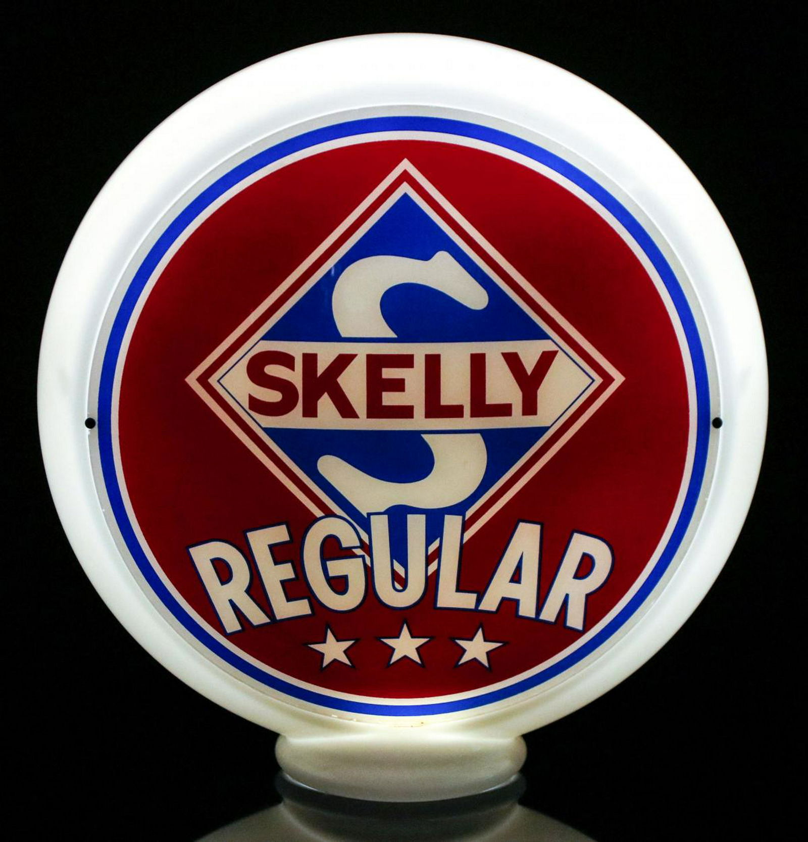 A VINTAGE MILK GLASS SKELLY REGULAR GAS PUMP GLOBE: Lenses each measure 13.5 inches in diameter in a 16.5 inch tall milk glass body. Provenance: The 45-year collection of Michael and Donna Hayes, West Plains, Missouri. We happily provide seamless in-ho