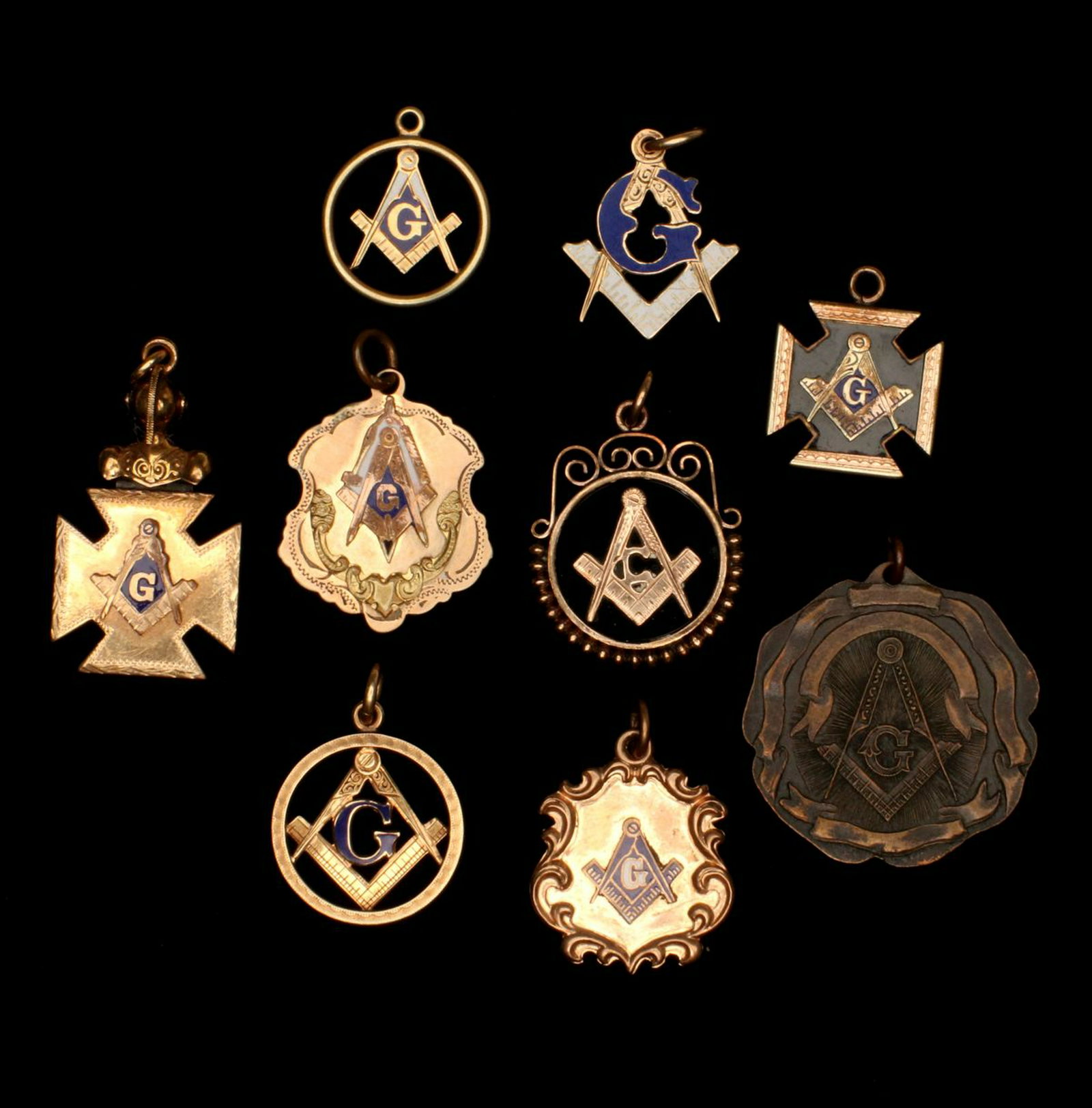 A COLLECTION OF NINE GOLD FILLED AND OTHER MASONIC FOBS: The collection as shown, with enamel highlights and one brass or bronze example. Measures 0.875 to 1.375 inches. Provenance: The 45-year collection of Michael and Donna Hayes, West Plains, Missouri. W