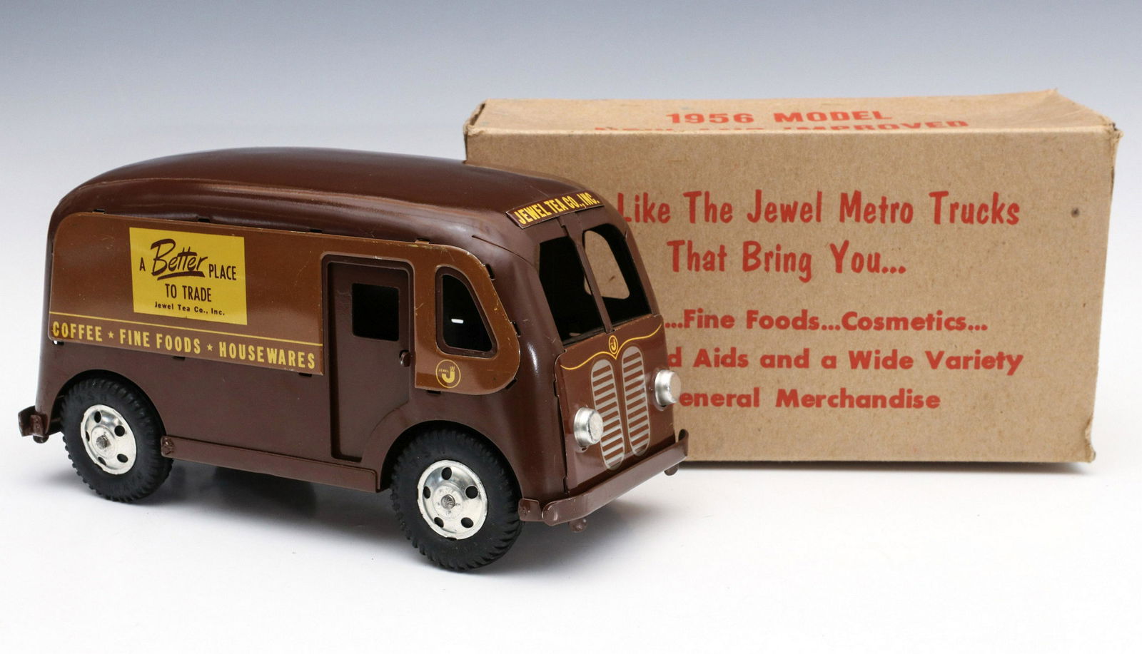 A CIRCA 1956 JEWEL T METRO DELIVERY VAN IN ORIGINAL BOX: The pressed steel model of a Jewel Tea delivery van, manufactured by Banner toys, original enamel paint with advertising graphics, the original box is included. Measures 4.75 x 9.25 inches. Provenance