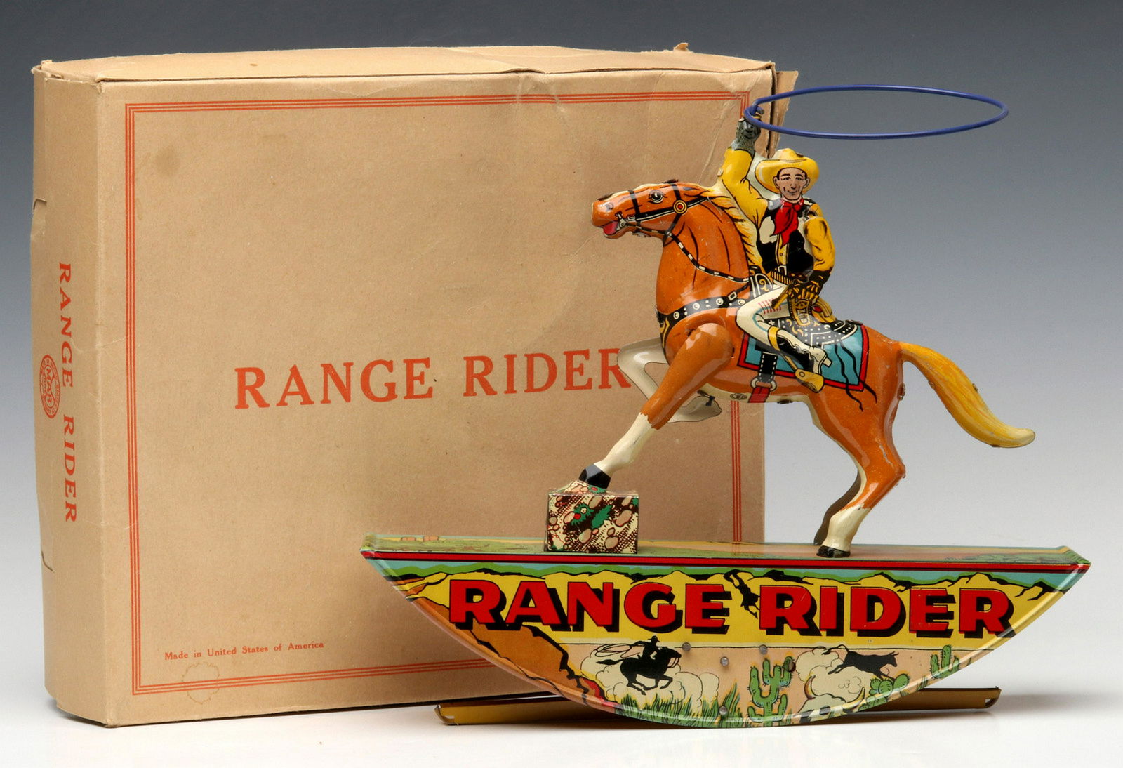 A MARX 'RANGE RIDER' TIN LITHO WIND UP TOY IN BOX: The colorful, detailed tin litho figure of a cowboy on horseback with animated lasso, the spring-powered mechanism drives a rocking mechanism and circular motion of the lasso. Measures 9.75 x 11 inche