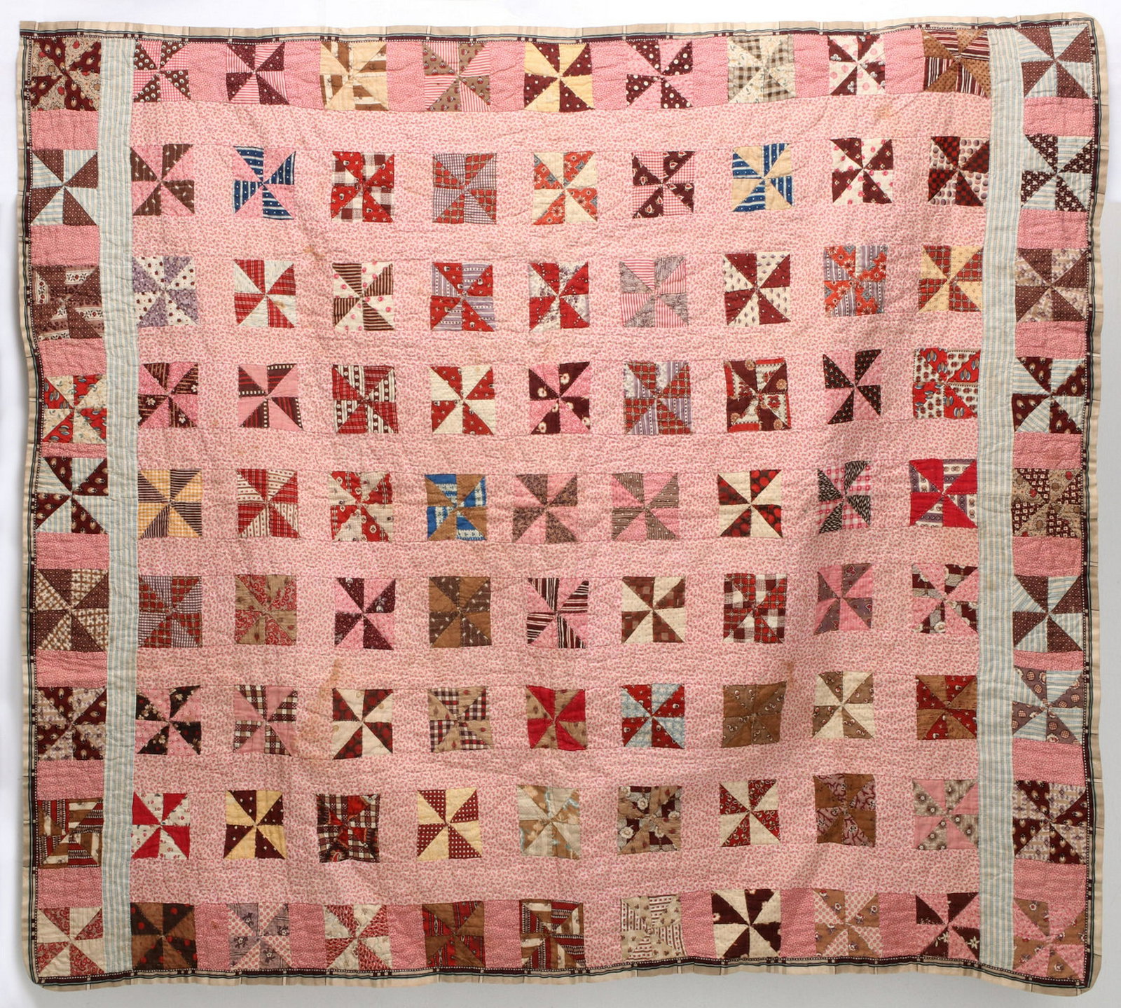 TWO 19TH CENTURY HAND QUILTED CRIB OR DOLL QUILTS: The Bowtie variant with 289 quarter-square calico triangle blocks, red border and backing, yarn-ties, hand quilting. Plus a Pinwheel pattern quilt comprised of 99 red sprigged calico blocks and blue t