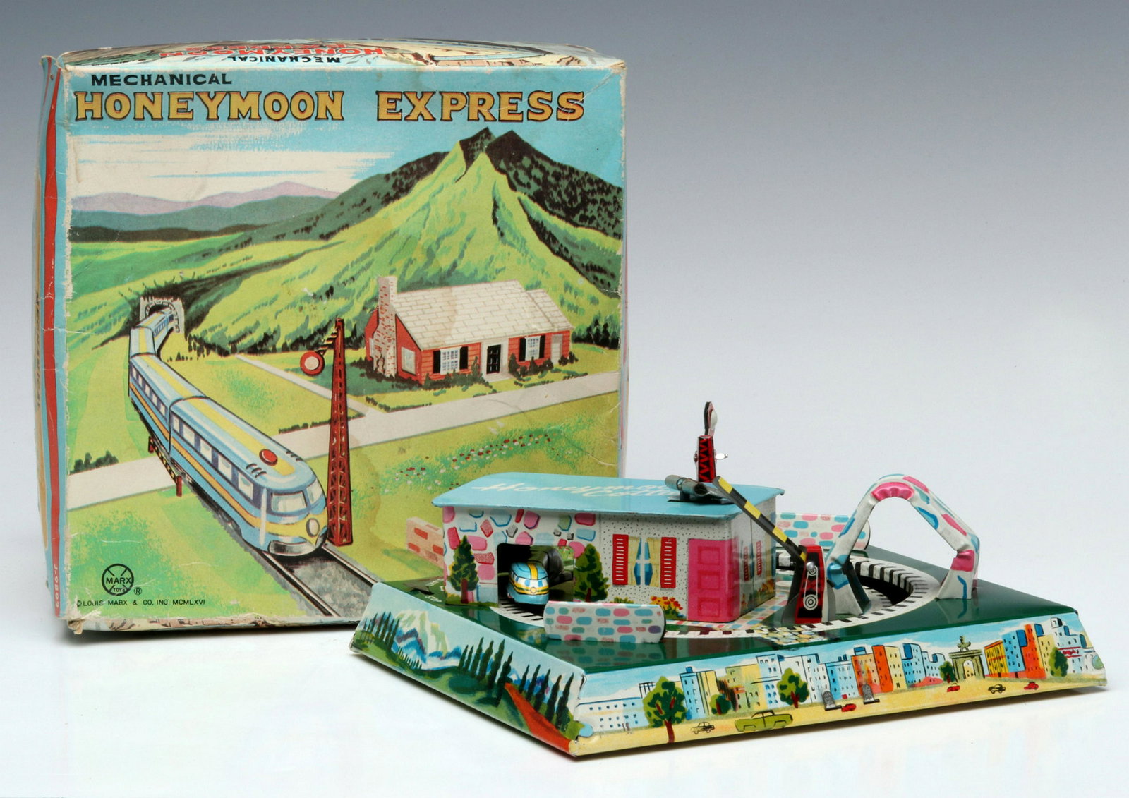 A MARX 'HONEYMOON EXPRESS' TIN LITHO WINDUP IN BOX: The rail travel version in its original box. Measures 2.5 x 7.25 x 7.25 inches. Provenance: The 45-year collection of Michael and Donna Hayes, West Plains, Missouri. We happily provide seamless in-hou