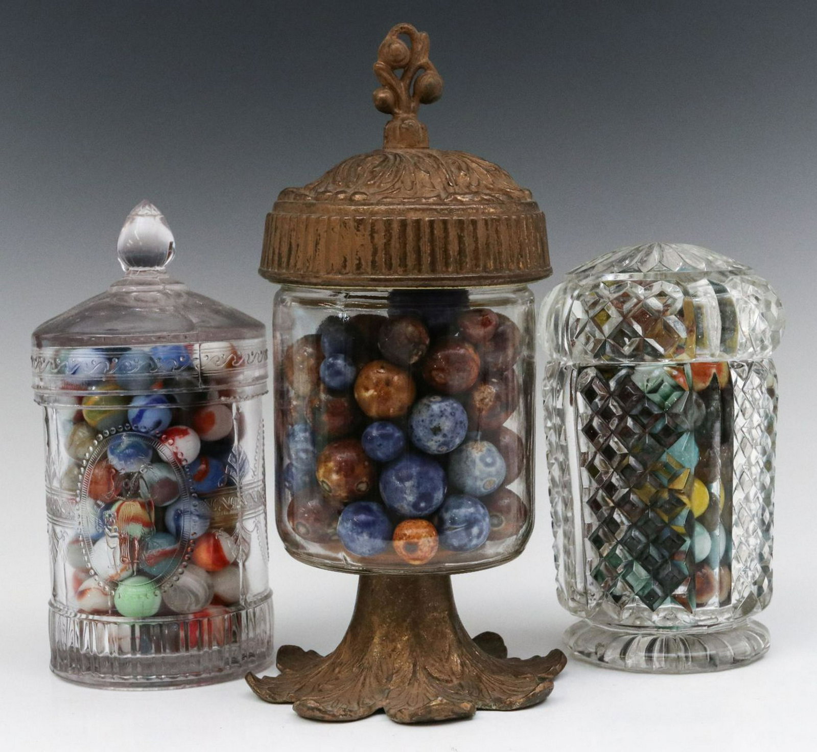 INTERESTING ANTIQUE CONTAINERS FILLED WITH MARBLES: A circa 1900 pattern glass marmalade jars and another interesting jar, all filled with marbles, two with machine made marbles and one with 19th century Bennington marbles. Marbles measure from 0.25 to