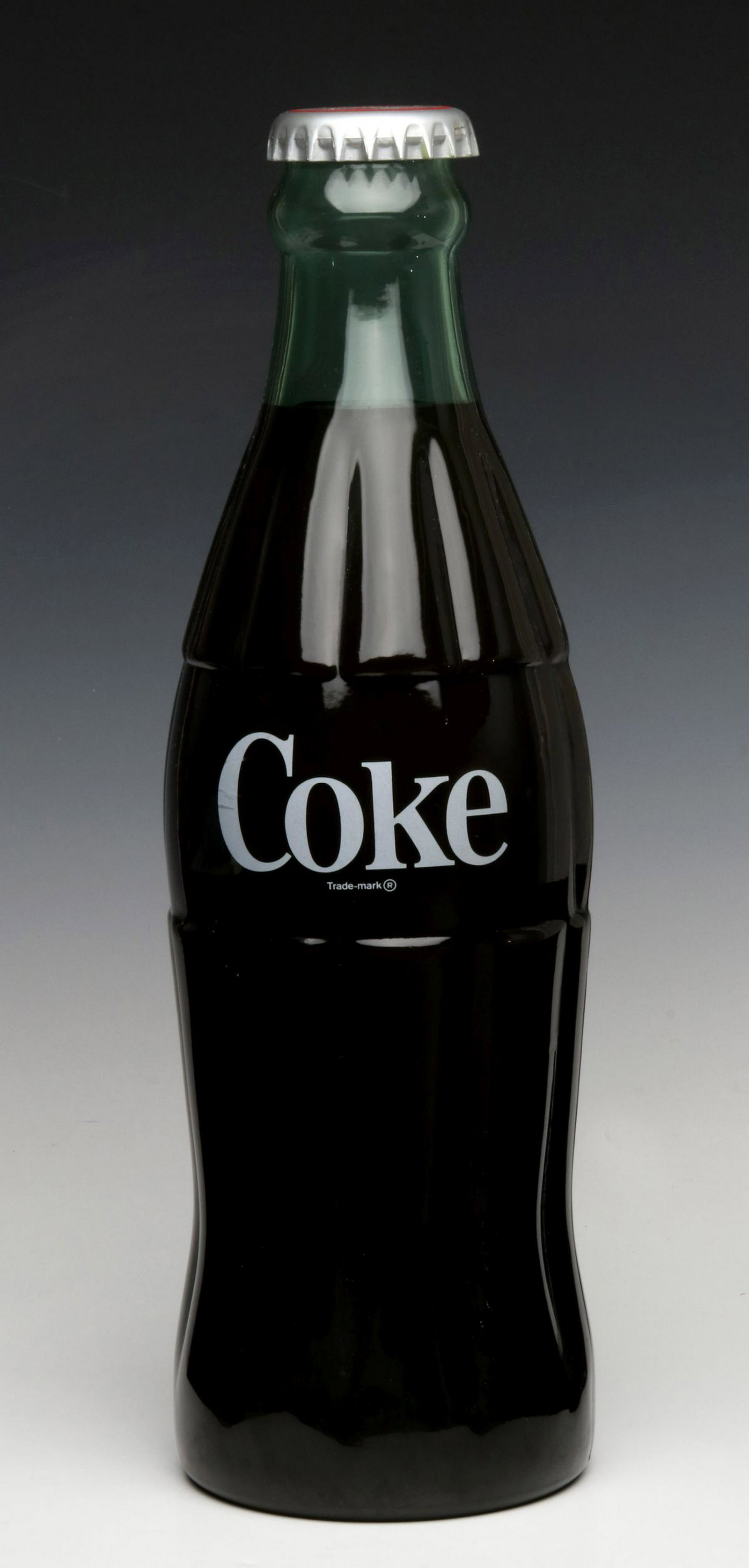 A 19-INCH COCA-COLA ADVERTISING DISPLAY POP BOTTLE: The glass bottle with coloring and paint detail. Measures 19.5 inches. Provenance: The 45-year collection of Michael and Donna Hayes, West Plains, Missouri. We happily provide seamless in-house packin