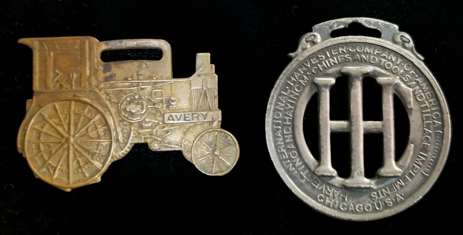 AVERY AND INTERNATIONAL HARVESTER WATCH FOBS C. 1900: The die-cut AVERY steam tractor along with and International Harvester logo fob. Measures 1.25 and 1.625 inches. Provenance: The 45-year collection of Michael and Donna Hayes, West Plains, Missouri. W