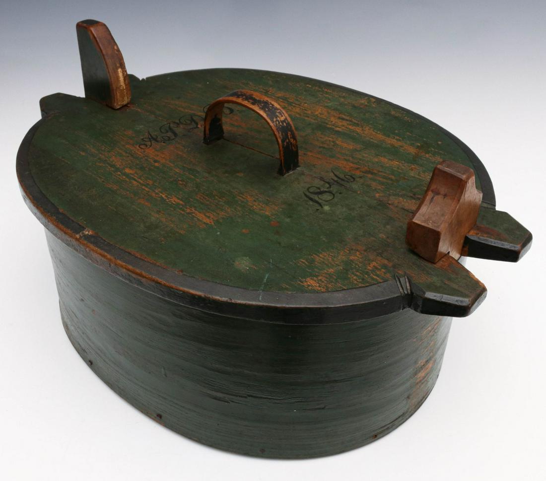 A GOOD 1846 SCANDINAVIAN BRIDE'S BOX IN OLD GREEN PAINT: The traditional form with cover and locking wood keys, wonderful bent wood handle with original black paint or stain, lace, wood peg and iron nail construction, hand painted initials and date of 1846 
