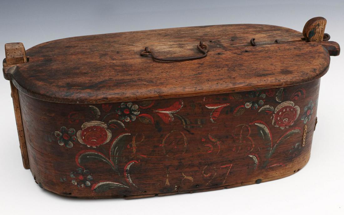 A SCANDINAVIAN BRIDE'S BOX WITH PAINTED FLORALS, 1897: The traditional form with locking cover, unusual iron wire closure and handle, the original painted floral decoration and date, great warm patina, interesting lace reinforcements. Measures 8.75 x 21.7