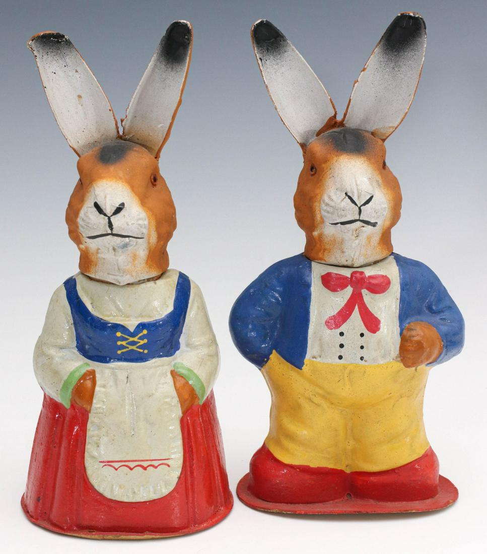 A PAIR OF VINTAGE GERMAN EASTER BUNNIES: The pair of mother and father papier mache Easter rabbit candy containers with glass eyes, signed Germany on their bases. Measures 9.5 x 4.25 x 3 and 9.25 x 4 x 4 inches. We happily provide seamless i