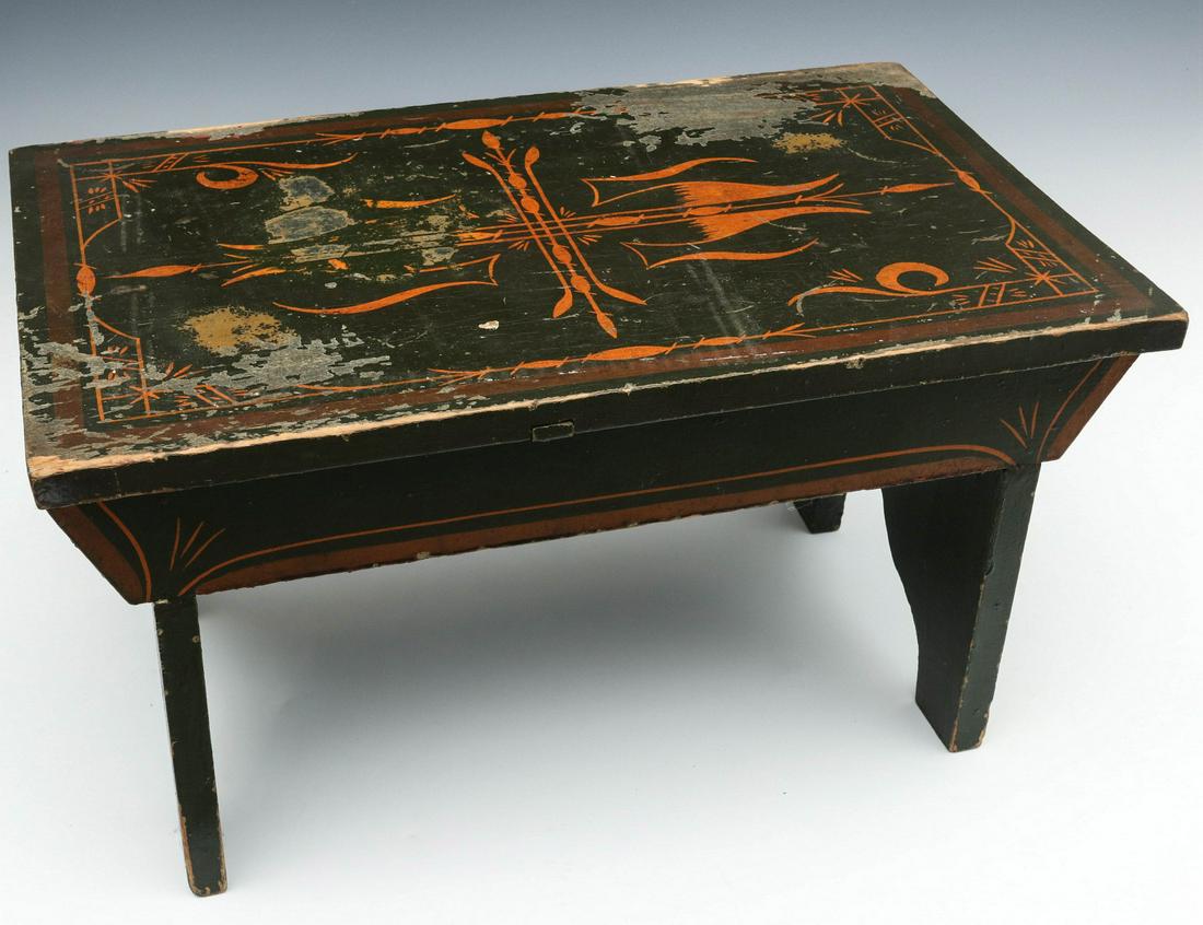 AN EARLY CRICKET STOOL WITH ORANGE DECORATION ON GREEN: The small stool with overhanging top, boot jack ends, original paint decoration with elaborate pin stripe and other decoration on dark green with brown bands. Measures 11.5 x 21 x 13.25 inches. We hap