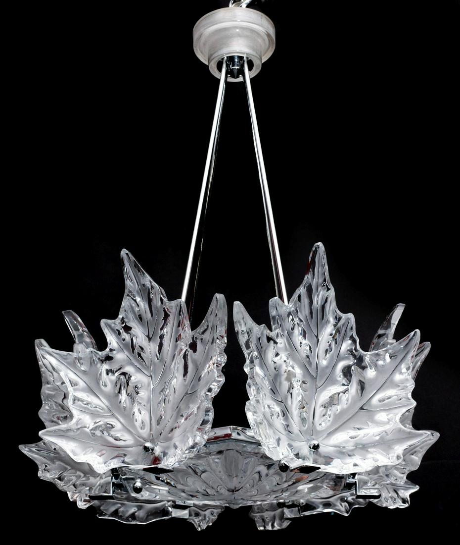 A LALIQUE CHAMPS-ELYSEES FRENCH CRYSTAL CHANDELIER: The French crystal and chrome mounts suspended form stepped circular ceiling cap, four chromed suspension rods, a horizontal circular crystal disc with frosted leaves signed Lalique France, six large 