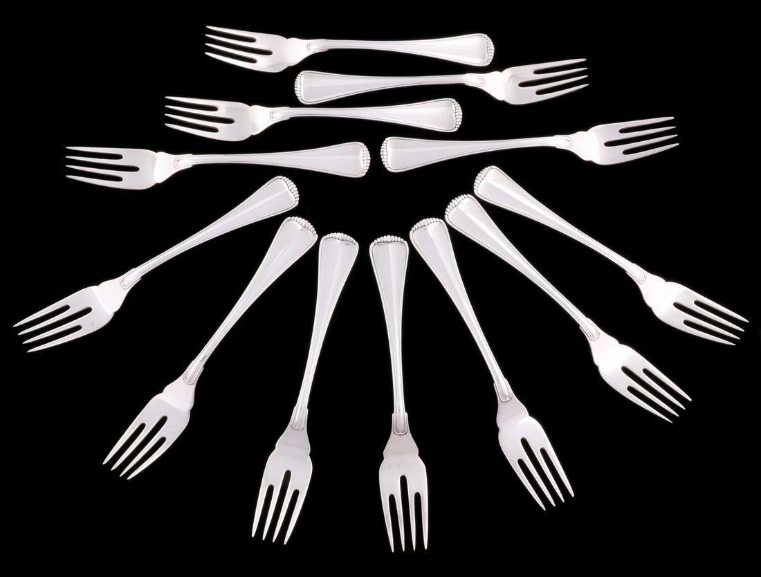 A BUCCELLATI 'MILANO' PATTERN STERLING FLATWARE SERVICE: The eighty piece set comprised of thirteen 7.5-inch dinner forks; twelve 6.75-inch salad forks; fifteen 5.5-inch teaspoons; ten 7-inch tablespoons; eleven 5.25-inch flat handled butter spreaders; twel