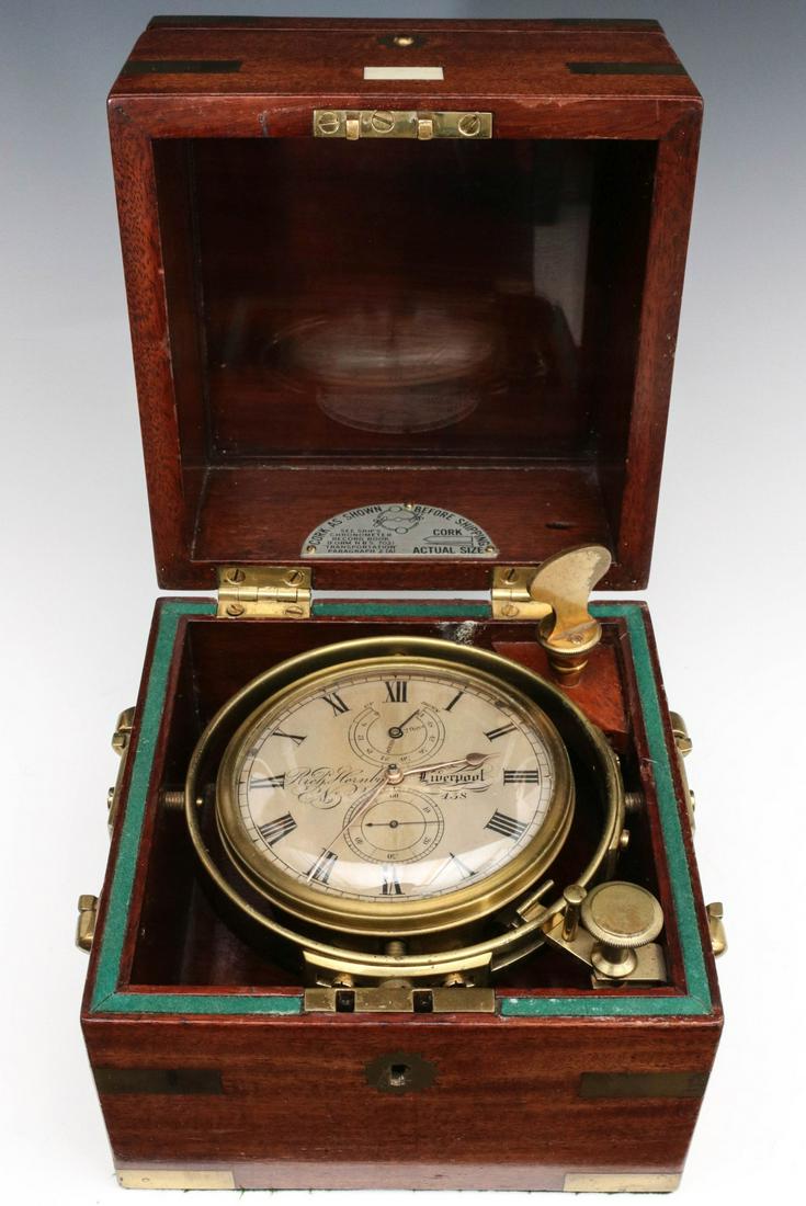 A19TH CENTURY RICH HORNBY LIVERPOOL NO. 438 CHRONOMETER: The two day chronometer from the second quarter of the 19th century, housed in a three stage brass bound mahogany case, with inlaid brass escutcheons, corners, edges, handle etc, the brass chain drive