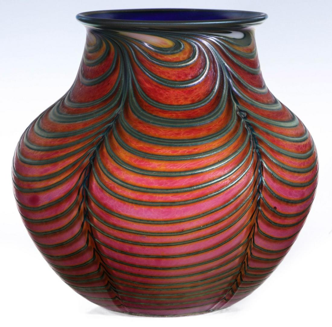 A FINE AND RARE DANIEL LOTTON VASE WITH THICK THREADING: Daniel Lotton (20th century) 1990 The bulbous coral-colored glass vase with flared blue rim and swelling ribs draped with thick external blue iridescent swags of glass thread swirled near the top rim,