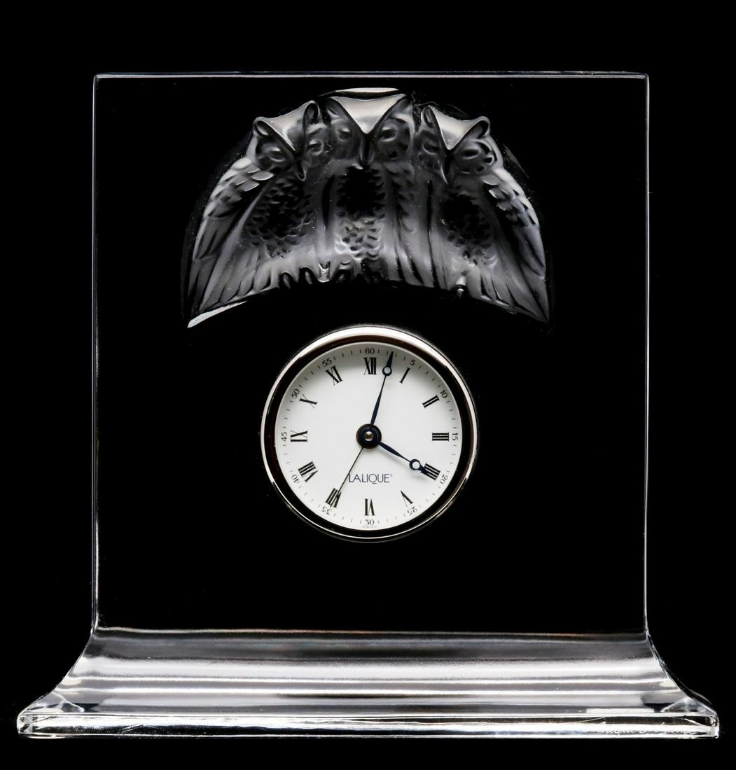 A LALIQUE FRENCH CRYSTAL CLOCK WITH FROSTED OWLS: The super clean French crystal tablet set with a quartz clock movement, sculpted image of three owls frosted in relief above the clock dial, signed Lalique on the face and in the crystal lower right. 