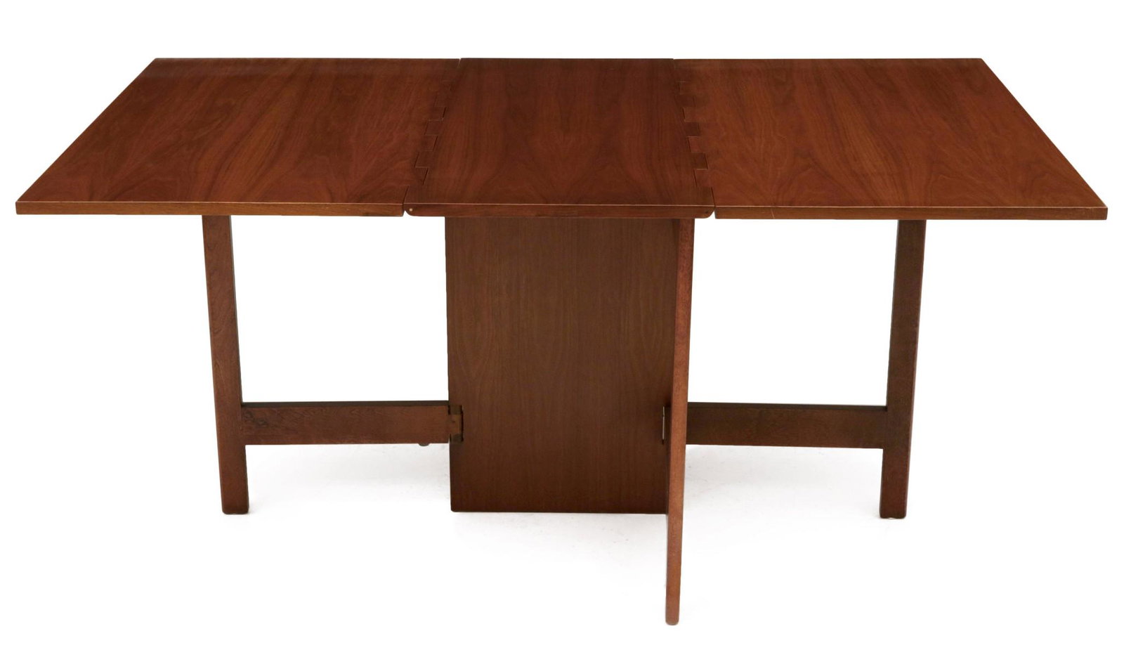 A GEORGE NELSON HERMAN MILLER GATE LEG DROP LEAF TABLE: The Modern design #4656 walnut table with long hinged drops supported by an architectural base with swing out supports, signed by foil/paper label. Measures 29.75 x 64.5 x 40 inches. We happily provid