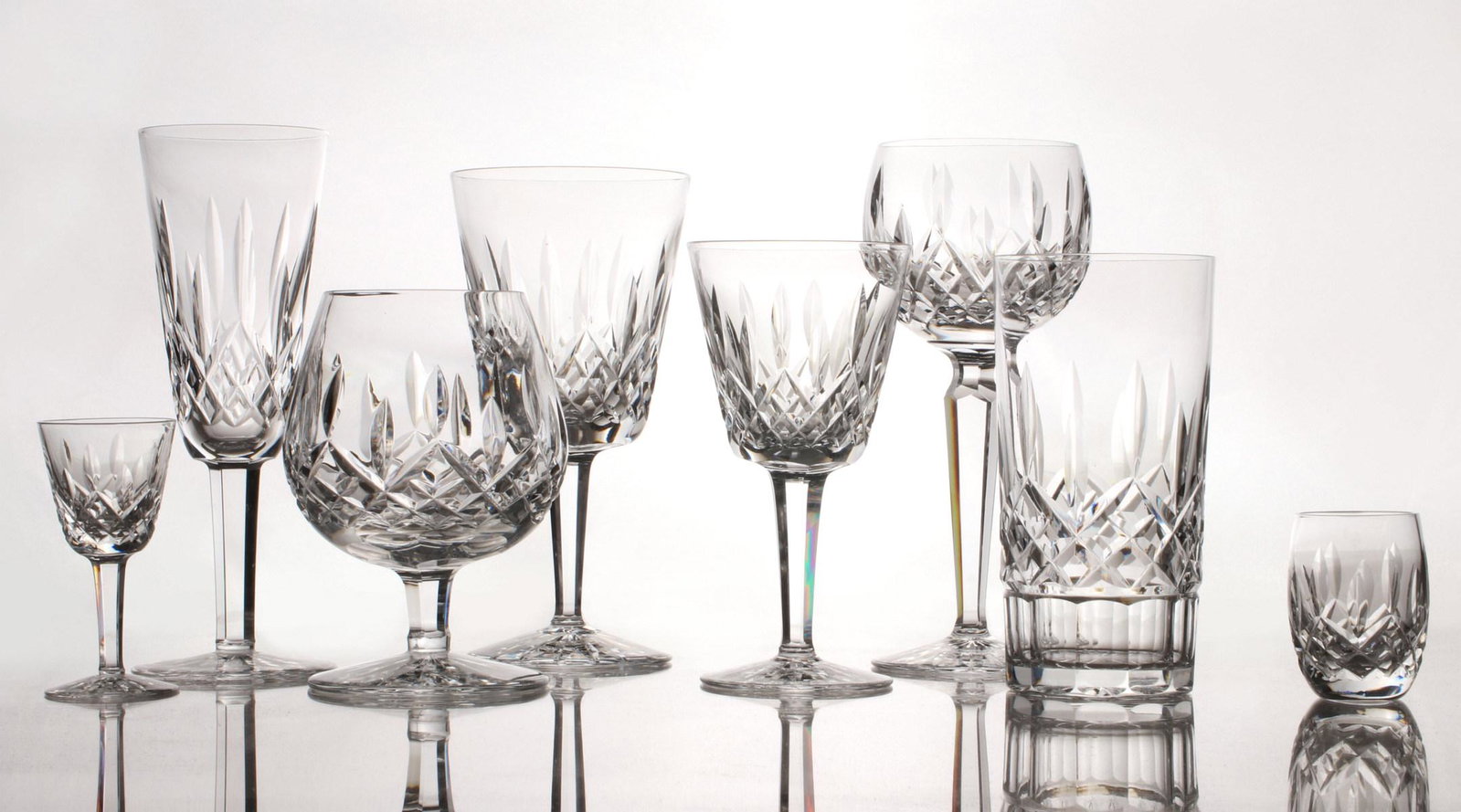 A 43 PIECE SERVICE OF WATERFORD 'LISMORE' IRISH CRYSTAL: The crystal service comprised of five 6.875-inch Water Goblets; eight 5.875-inch Claret Wine glasses; eight 7.5-inch Wine Hocks; eight 5.75-inch Highball glasses; eight 7.25-inch Fluted Champagne glas