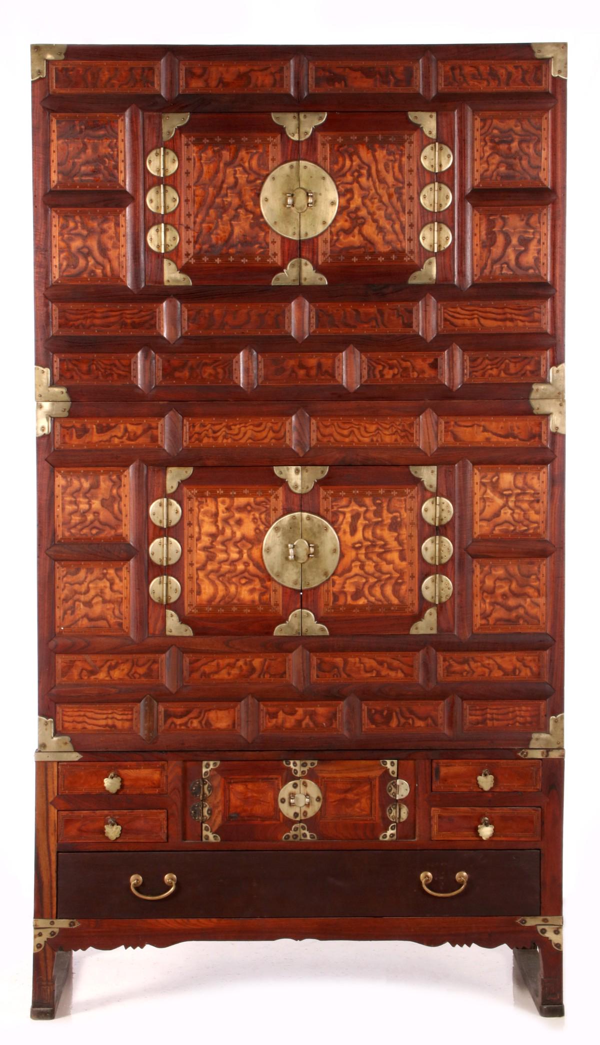 A 19TH CENTURY KOREAN TANSU WITH MARQUETRY DESIGNS: The two-piece cabinet with highly figured woods, multiple divided panels bordered in marquetry inlays, brass mounts, and four drawers with inlaid geometric designs. Measures 65 x 35.5 x 16.75 inches. 