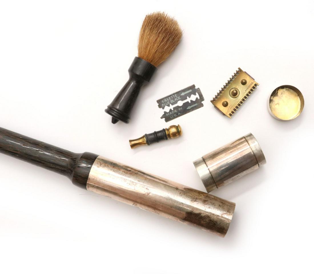 A RARE STERLING TOP CANE WITH HIDDEN SHAVE KIT C. 1900: The wood shaft that strongly resembles Wenge wood tipped in horn and mounted with a capped cylindrical sterling silver handle that contains a shaving brush with exotic wood handle, early safety razor 