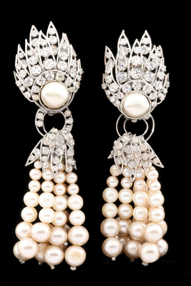 COSTUME JEWELRY EARRINGS ATTRIBUTED TO IRADJ MOINI: The rhinestone earrings with detachable faux pearl drops, Art Deco style influence, signed Iradj Moini on the clip-on backs. Measures 4.5 x 1.25 inches. We happily provide seamless in-house packing an
