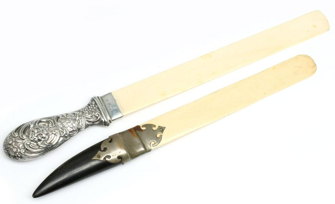 EBONY AND STERLING SILVER HANDLED ANTIQUE PAGE TURNERS: The larger having a London sterling silver handle embossed in rococo swirls centered by a visage mask and with date mark for 1899; the smaller with nickel mounts and ebony(?) handle. Measures 16.25 x