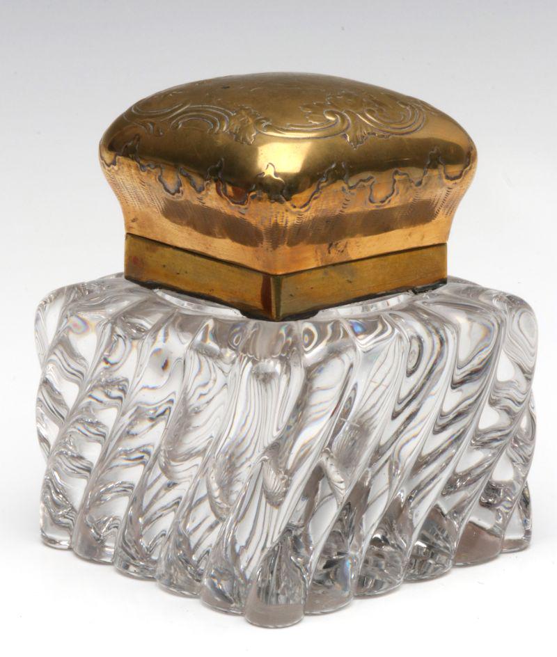 AN ANTIQUE SWIRLED RIB GLASS INK WELL WITH BRASS TOP: The heavy high-rib swirled glass ink well with brass repousse' top, original glass insert, cut ray and polished base, unsigned. Measures 5.5 x 4 x 4 inches. We happily provide seamless in-house packin