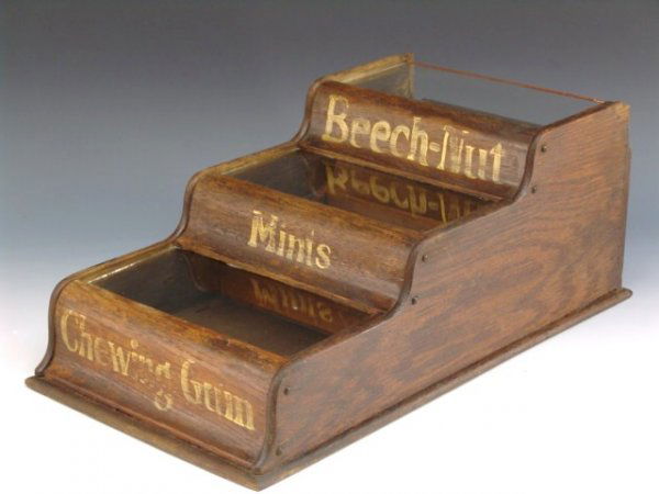 3 TIER WOODEN BEECHNUT GUM DISPLAY: Three tier wood & glass counter top display case for Beechnut Chewing Gum and Mints measures 7 3/4" tall by 10 1/2" wide by 19 1/2" deep. There is a 2 1/4" sliver chip of wood off the top back left wi
