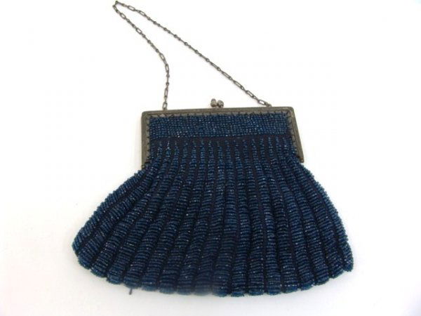 ANTIQUE BEADED PURSE WITH ORNATE FRAME: Nice antique purse with its original silk lining and ornate frame. Measures 6 inches by 8 wide at the widest point. This is just one of nearly 400 lots to be sold from a beautiful Victorian home in th