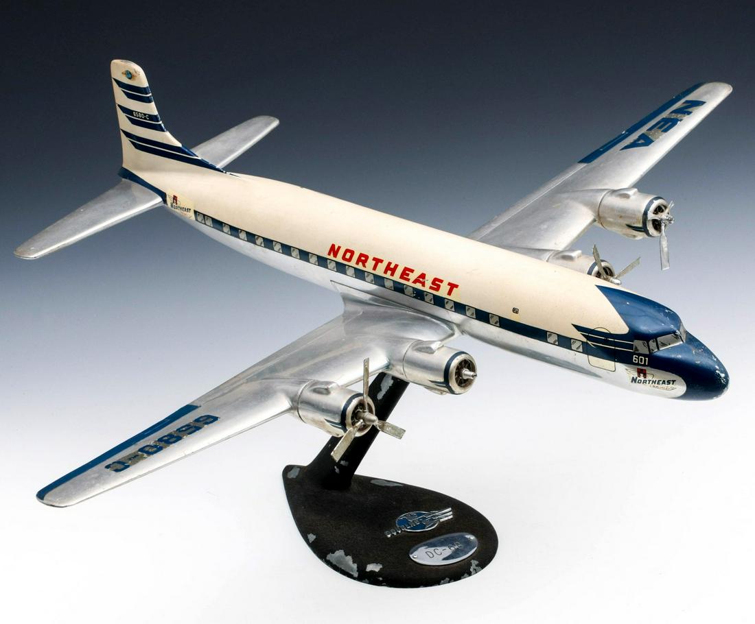 A DOUGLAS DC-6B TRAVEL AGENT DESK MODEL AIRLINER C 1950: The unusual desk-top model of the DOUGLAS DC-6B in service for passenger travel and cargo circa 1946 to 1958, model of the piston-powered prop drive plane built by Lockheed for use in WWII and re-work