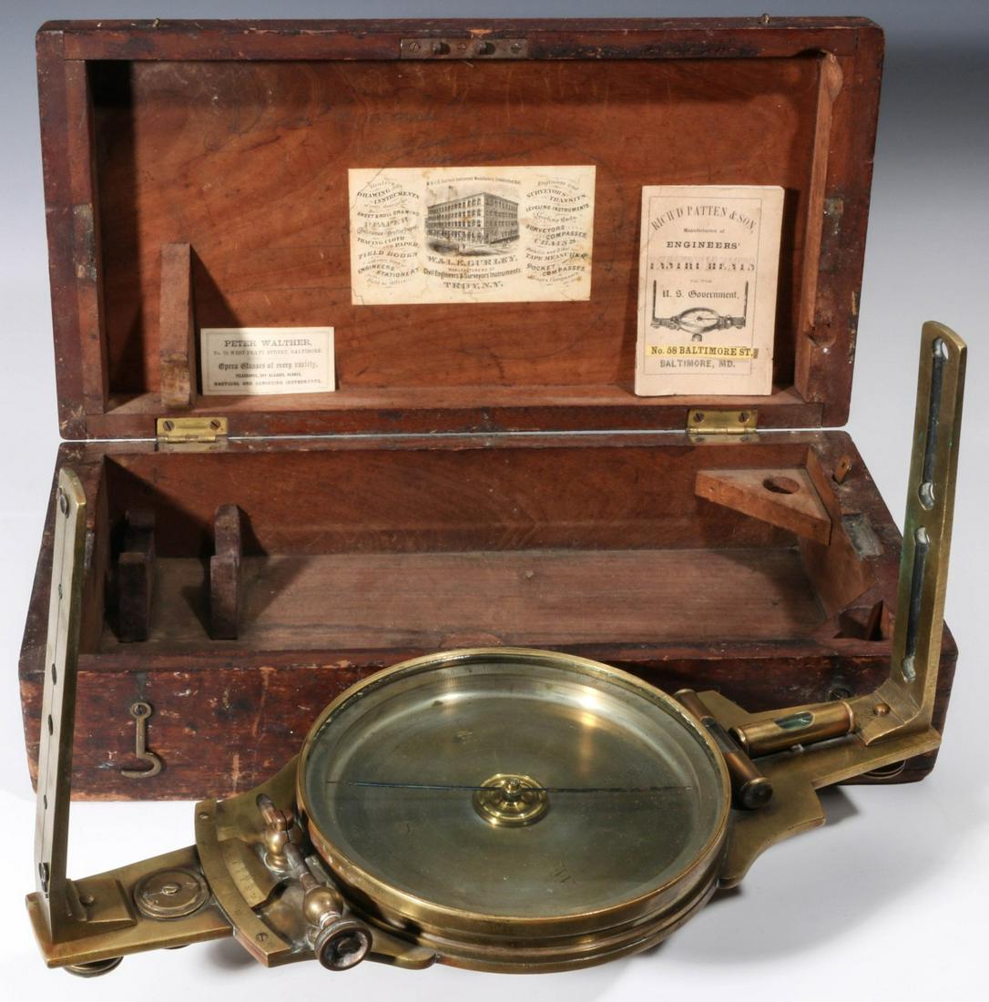 A 19TH CENTURY BRASS VERNIER COMPASS SIGNED GURLEY: The brass instrument with silvered dial lettered W & L.E. Gurley, Troy N.Y. with fleur-des-lis, original mahogany case with label. Measures 4.75 x 16.5 x 8.5 inches. Provenance: The Collection of Ed M