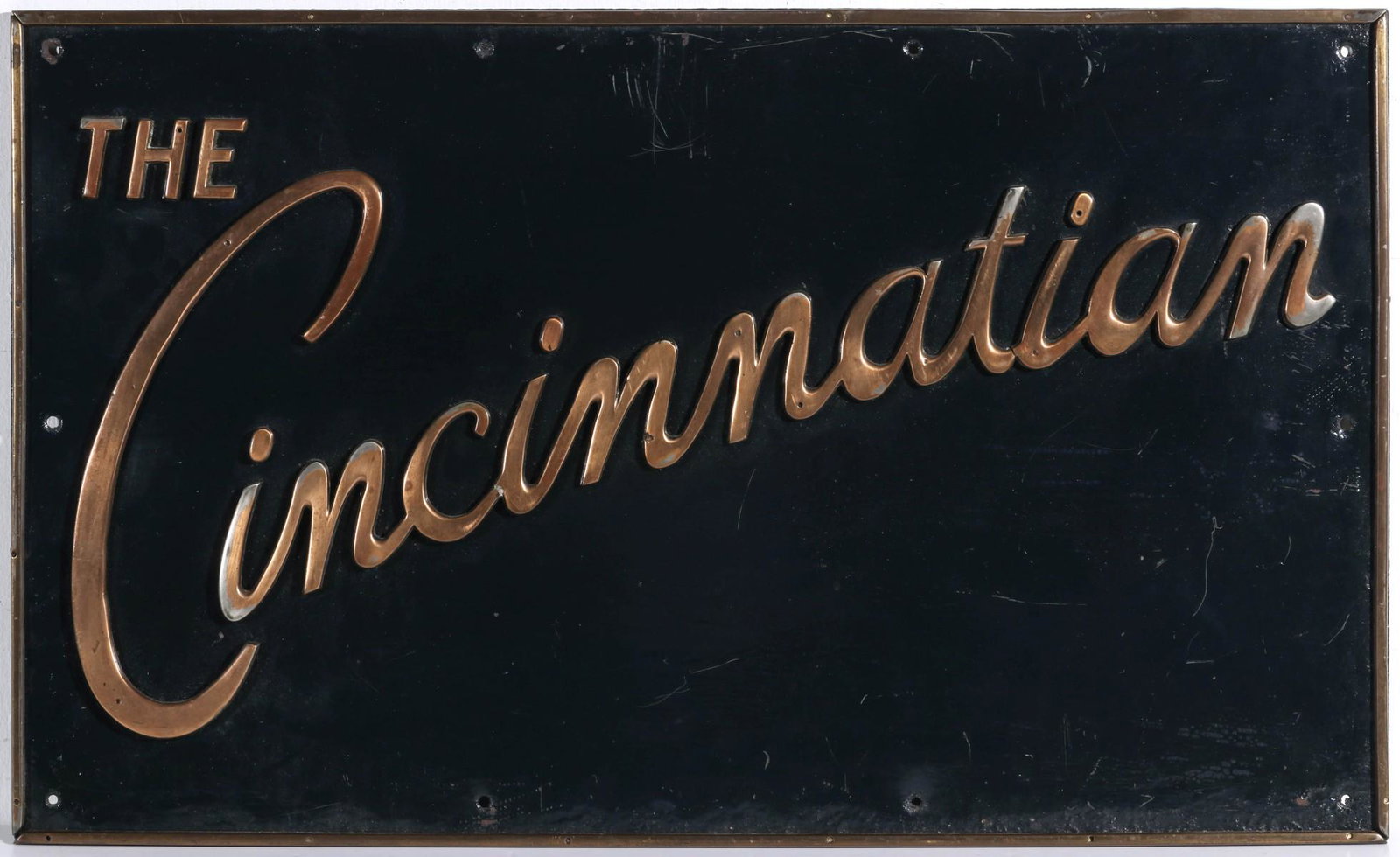 AN IRON AND BRASS SIGN FOR THE B&O RR 'CINCINNATIAN': The sheet iron rectangular sign with applied brass frame and lettering, the Cincinnatian was a high speed luxury line that ran various routes from just after WWII, this heavy iron sign with applied br
