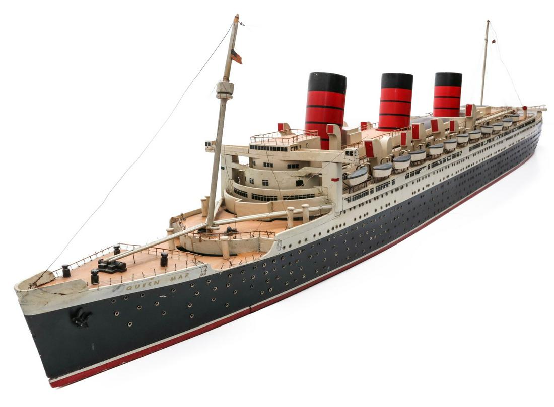 A LIGHTED WATERLINE MODEL OF THE QUEEN MARY 6 FEET LONG: The highly detailed model in accurate reproduction, original paint, interior lighting, the mast displays a 48 star American flag (the 48 star flag flew over America until 1949), porcelain light socket
