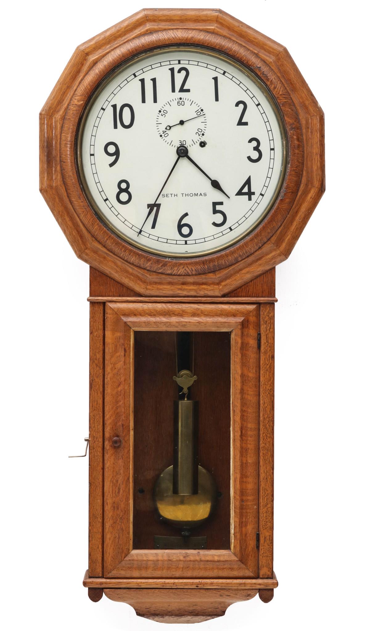A SETH THOMAS OAK NUMBER 3 ONE-WEIGHT REGULATOR: The twelve-sided head with circular dial and rectangular drop case, the older painted metal dial is assumed to be a replacement, single winding hole, Arabic numeral chapter ring, single brass sleeve w