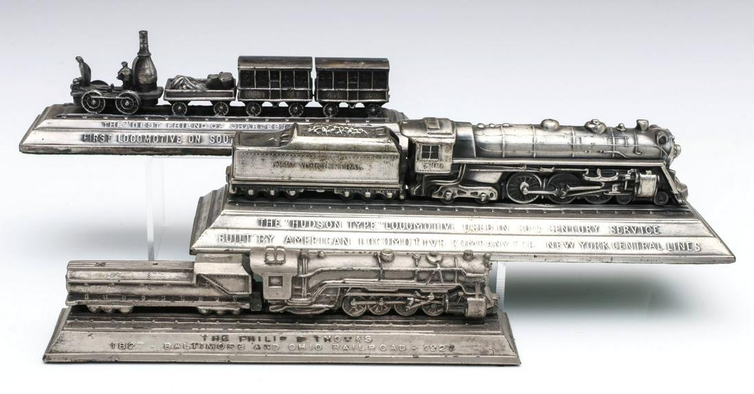 NYC AND B&O AND 1830 CHARLESTON DESK ORNAMENTS: The three silvered white metal ornaments depicting accurate models of 'The Best Friend of Charleston' First Locomotive on Southern Railway; plus a Baltimore and Ohio locomotive and tender with loose b