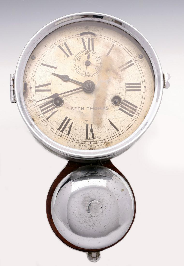 A SETH THOMAS 'BELL UNDER' MARINE CLOCK: The nickel plated wall mount ship's clock with lower bell, 30 hour time and strike movement, original paper label remains verso. Measures 3.5 x 10.25 x 6 inches. Provenance: The Collection of Ed McHug