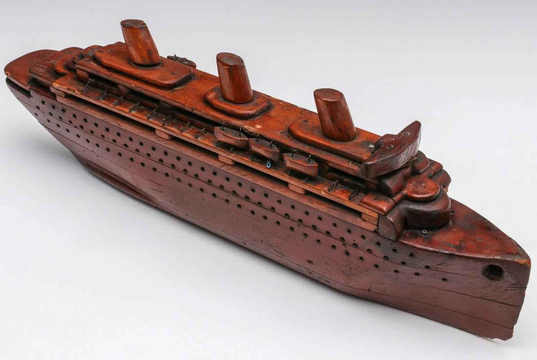 A MID 20TH CENTURY FOLK ART MODEL OF PASSENGER SHIP: The yellow pine model with simple details. Measures 6.25 x 20.25 x 2.5 inches. Provenance: The Collection of Ed McHugh, Massillon, Ohio We happily provide seamless in-house packing and shipping servic