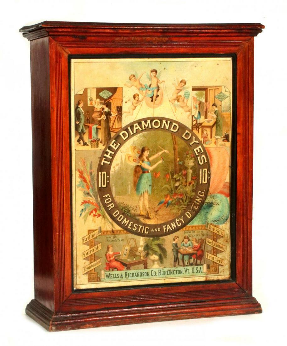 A GOOD EARLY DIAMOND DYES ADVERTISING CABINET: The circa 1890 Country Store merchandising cabinet, colorful lithographed tin insert with woodland fairy in the center and 10 cent graphics, various vignettes in the four corners demonstrate uses that