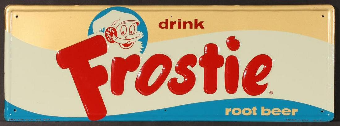 AN EMBOSSED TIN FROSTIE ROOT BEER ADVERTISING SIGN: The self-framed single-sided tin sign in four colors pictures the Frostie Root Beer mascot and graphics, unusual colors, Press Sign Co St. Louis 12-64. Measures 10 x 28 inches. We happily provide seam