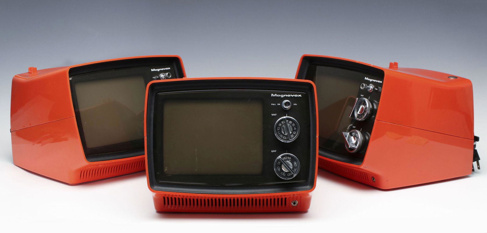 PETER MAX POSTER AND SPACE AGE MAGNAVOX 1T5255 TVs: An interesting lot comprised of three Magnavox red plastic Space Age UHF/VHF televisions. Plus, a print approximately 21 x 33 inches frame size after Peter Max titled Magical Moment, circa 1974, print