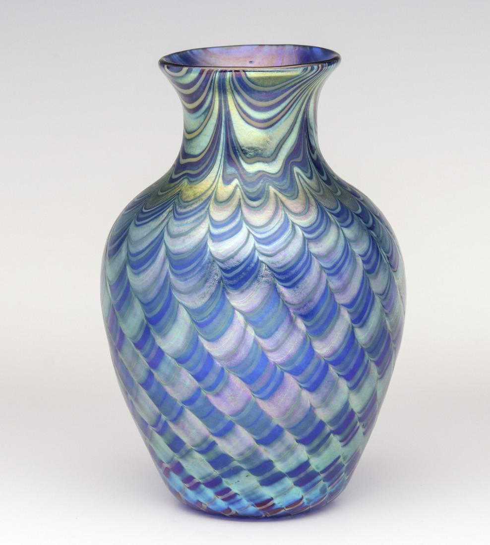AN ORIENT AND FLUME ART GLASS VASE WITH UNUSUAL FINISH: Late 20th Century. The classic form with flared mouth in transparent blue glass, King Tut type decoration at the neck and tight spirals of looping in rows that encircle the body, engraved signature on